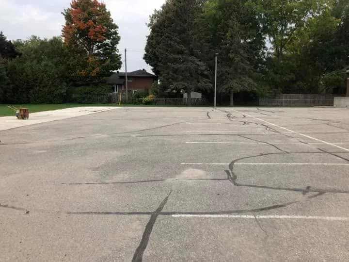 Cracked asphalt surface condition before review.